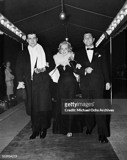 Actor Richard Greene with actress Alice Faye and friend attend an event in Los Angeles, California.