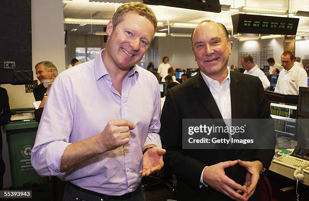 Comedian Rory Bremner and BGC Chief Executive Lee Amaitis walk on to the trading floor during a charity trading day, September 12, 2005 hosted by...