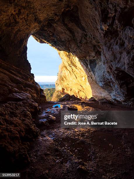 interior of a cave with water puddles. - spelunking stock-fotos und bilder