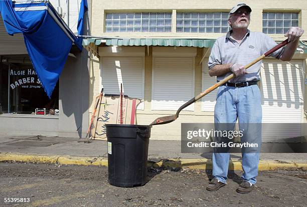Allen Hailey cleans up in front of his barber shop on September 13, 2005 in Metairie, Louisiana. Business owners for cities in Jefferson Parish have...