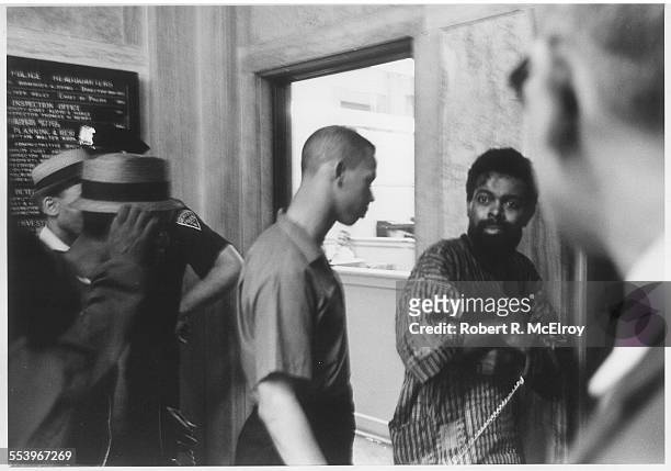American poet and playwright LeRoi Jones in a police station, bloodied and in chains after being arrested during a riot, Newark, New Jersey, July 14,...