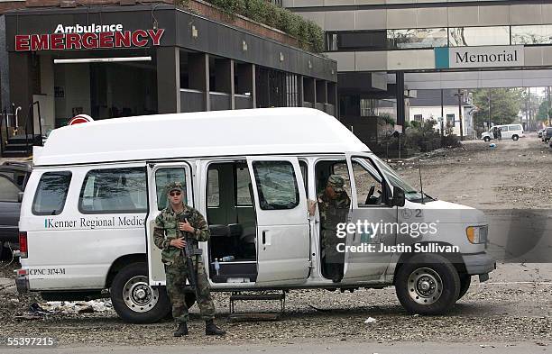 Members of the National Guard stand guard in front of the Memorial Hospital September 13, 2005 in New Orleans, Louisiana. 45 patients were found dead...