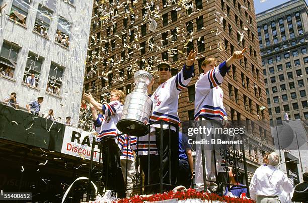 Hockey player Mark Messier of the New York Rangers holds the Stanley Cup aloft as he and his teammates celebrate their victory over the Vancouver...