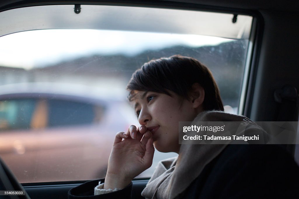Woman thinking about her future in her car