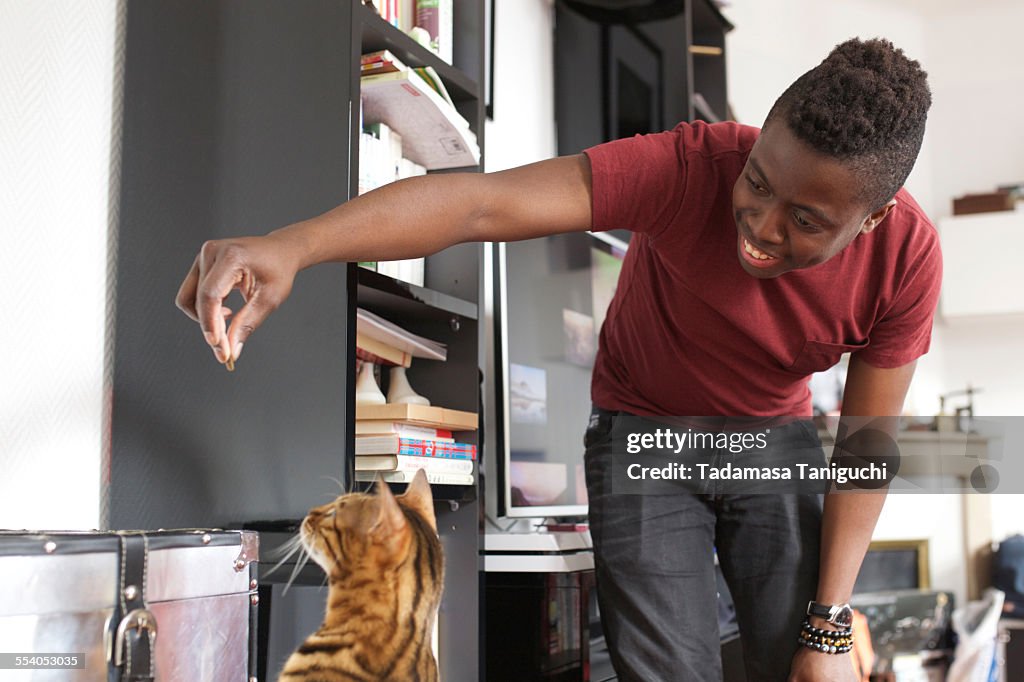 Man playing with his pet cat