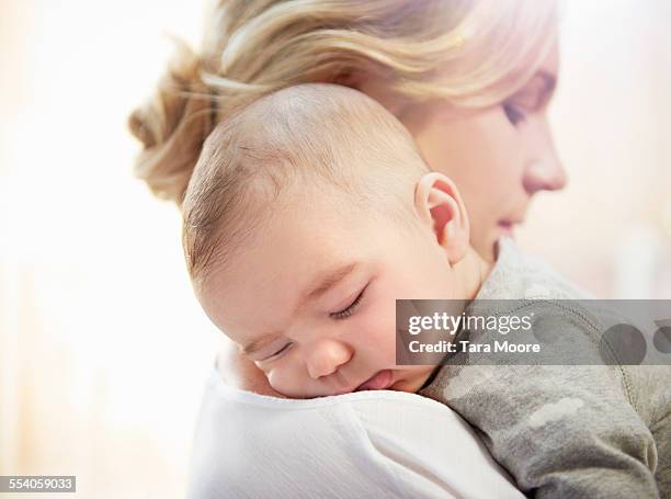 baby sleeping on mother's shoulder - mother sleeping baby bildbanksfoton och bilder