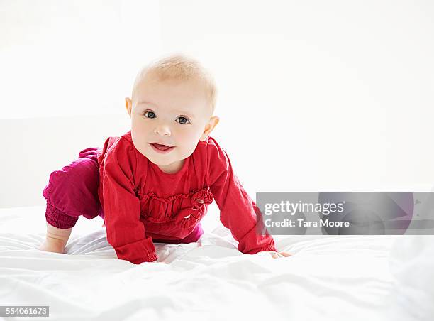 happy baby girl smiling - bed on white stock pictures, royalty-free photos & images