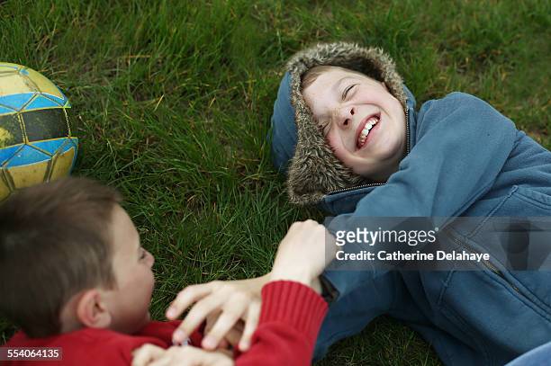 2 brothers fighting on the grass - play fight stock pictures, royalty-free photos & images