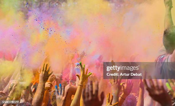 people celebrating the holi festival in barcelona. - holi foto e immagini stock