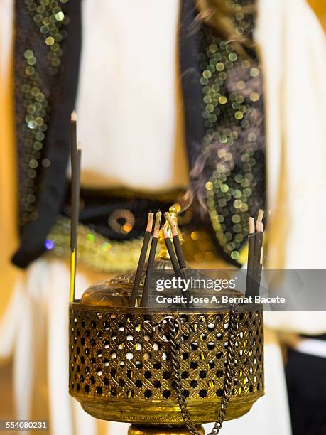 bars of incense on a former burner of bronze - pomander stock pictures, royalty-free photos & images