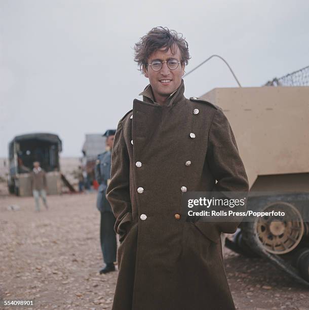 Guitarist with The Beatles, John Lennon pictured wearing a military greatcoat and dressed in character as Muskateer Gripweed on location in Almeria,...