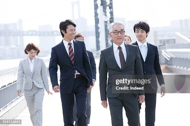 six people walking - man with gray hair stock pictures, royalty-free photos & images