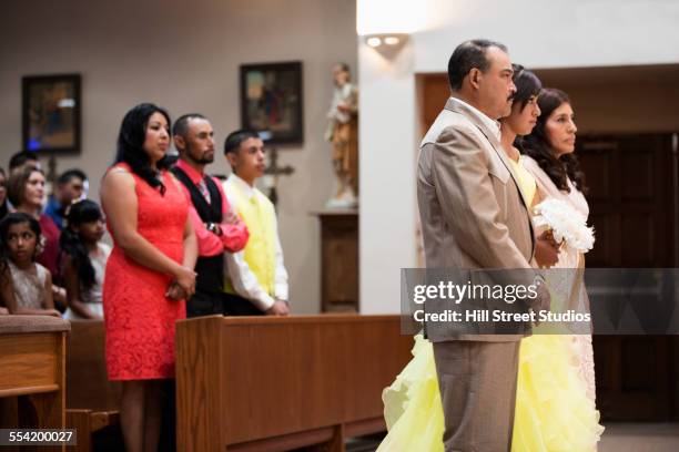 hispanic family celebrating quinceanera in catholic church - glamourous granny stockfoto's en -beelden