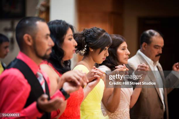 hispanic community celebrating quinceanera in catholic church - godparent stock pictures, royalty-free photos & images