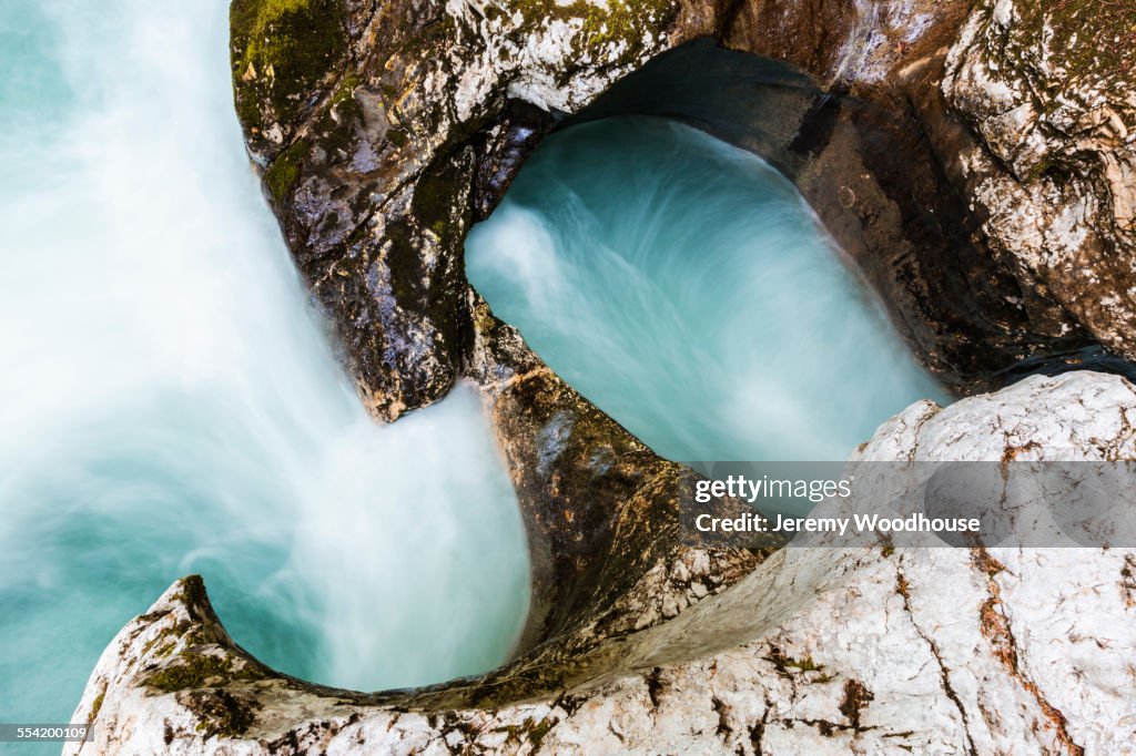 High angle view of water swirling near rock formations