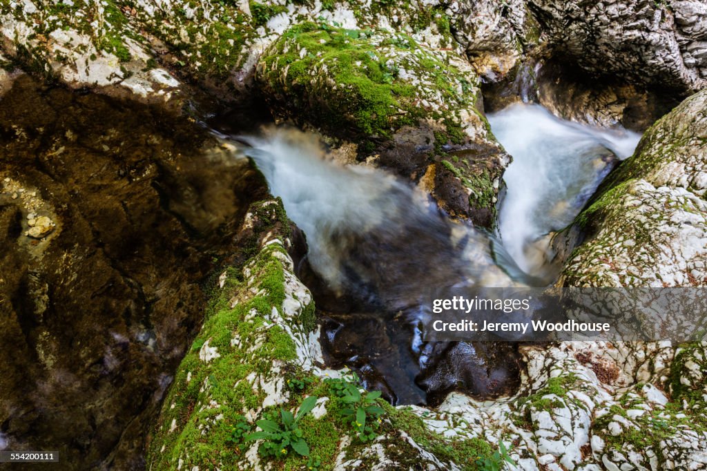 High angle view of water swirling near rock formations