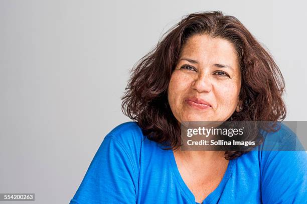 close up of hispanic woman smiling - one woman only 45 49 years stock pictures, royalty-free photos & images