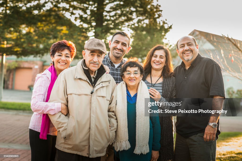 Multi-generation family smiling together outdoors