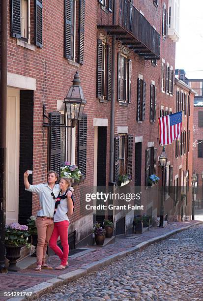 couple on famous street - acorn street boston stock-fotos und bilder