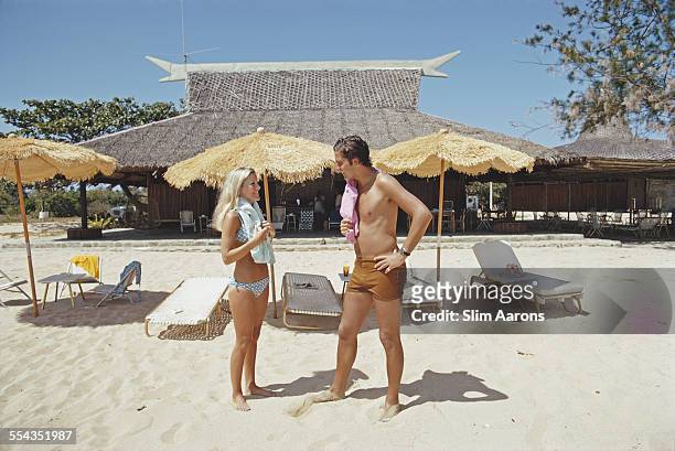 Guests relax on the beach of a private island owned by Philippine Airlines President, Benigno Toda Jr., Philippines, February 1973.