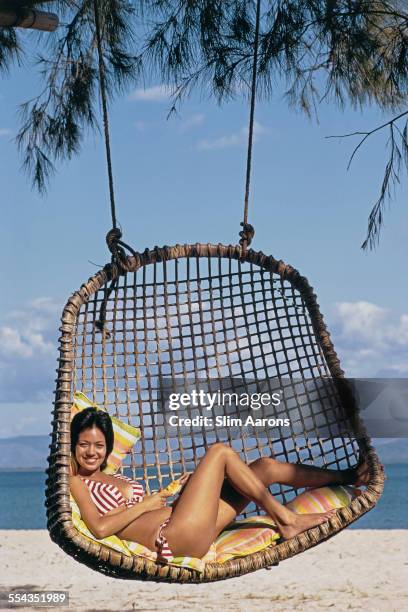 Guest relaxing on the beach of a private island owned by Philippine Airlines President, Benigno Toda Jr., Philippines, February 1973.