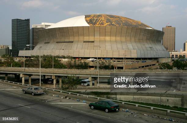 Abandoned cars remain on Interstate 10 in front of the heavily damaged Superdome September 14, 2005 in New Orleans, Louisiana. After being damaged by...