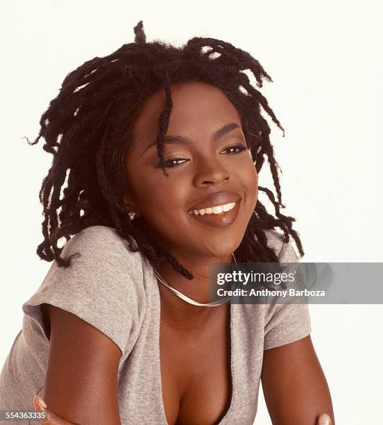 Portrait of American pop and rhythm & blues musician Lauryn Hill as she poses against a white background, 1998.