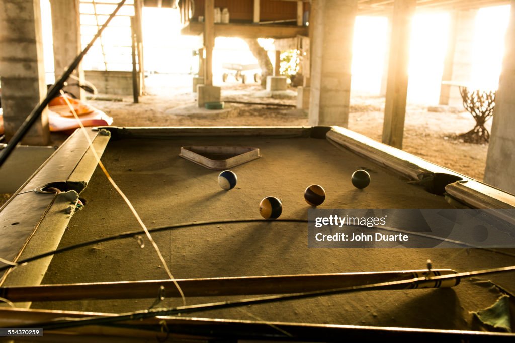 Fishing rods and pool cues on pool table