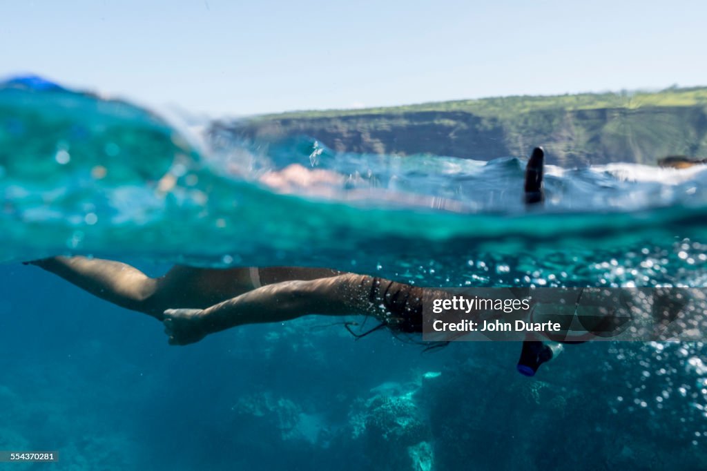 Mixed race woman snorkeling in tropical ocean