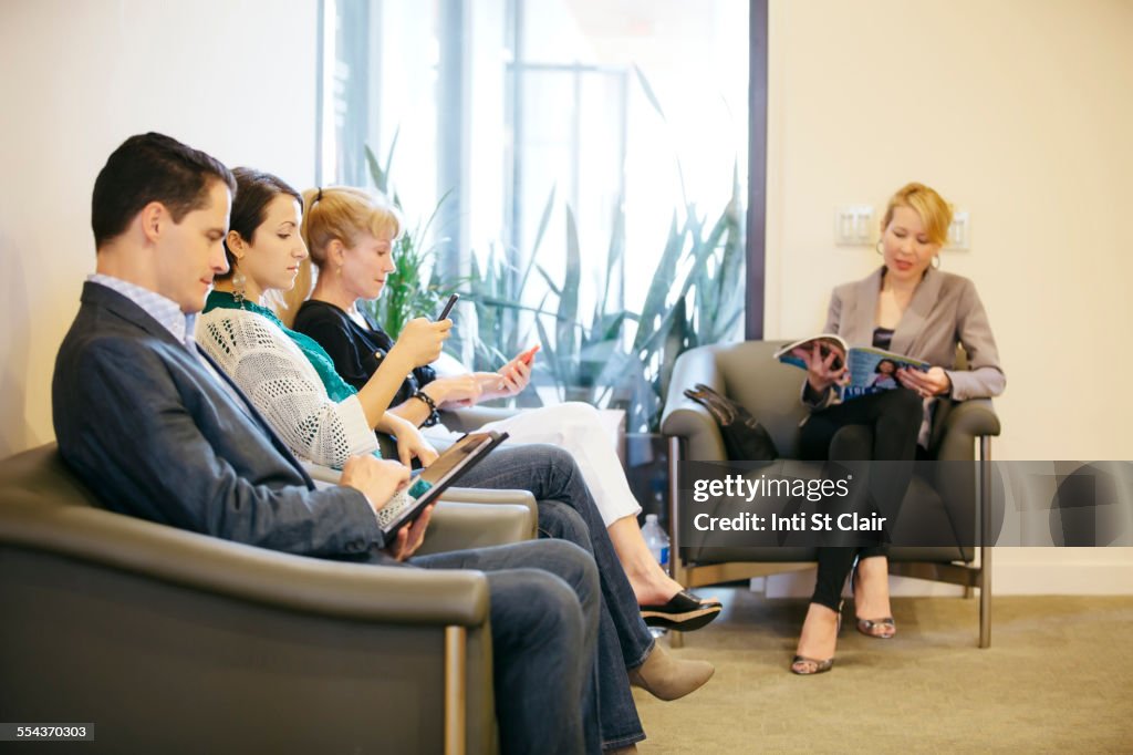 Business people waiting in office lobby