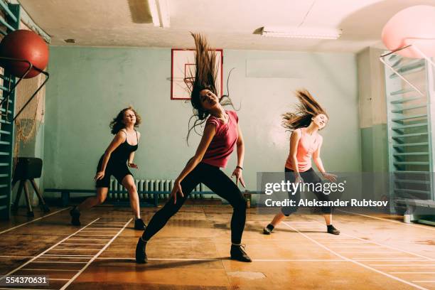 Caucasian dancers rehearsing in gym