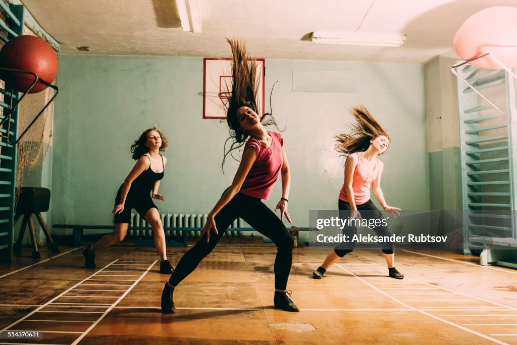 Caucasian dancers rehearsing in gym