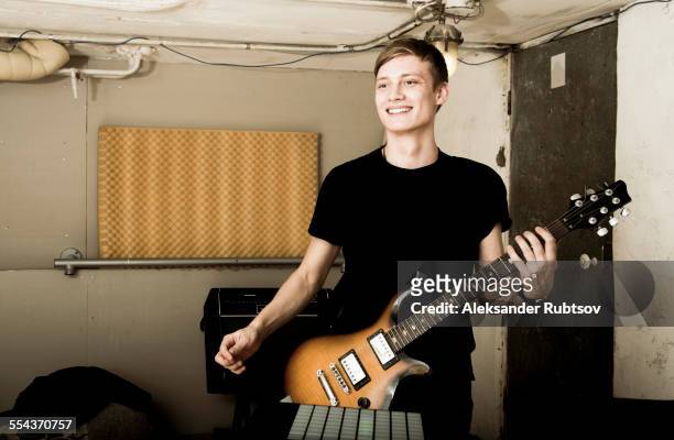 caucasian man playing electric guitar in rock band - male guitarist stock pictures, royalty-free photos & images