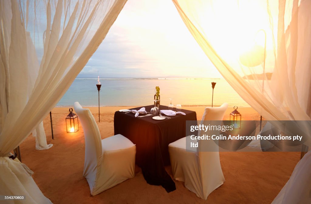 Table prepared for romantic dinner at beach