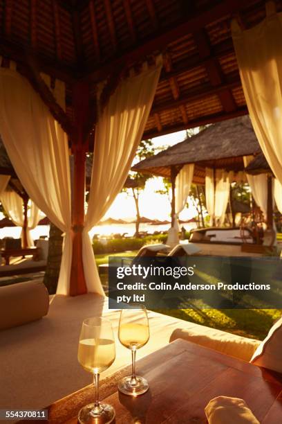 glasses of white wine in cabana - bali luxury stock pictures, royalty-free photos & images