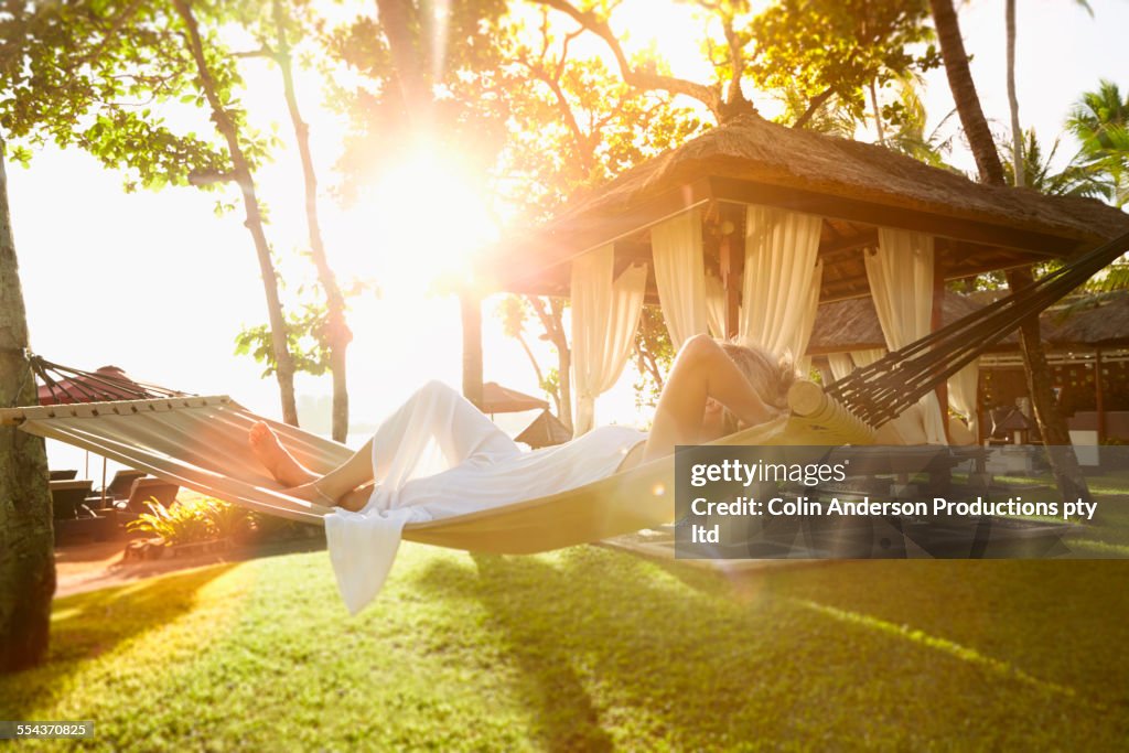 Caucasian woman relaxing in hammock