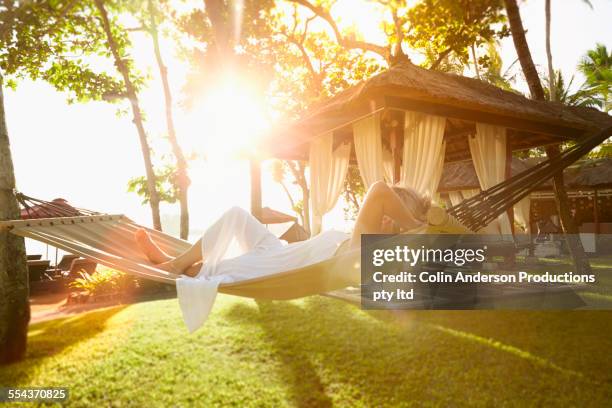 caucasian woman relaxing in hammock - bali luxury bildbanksfoton och bilder