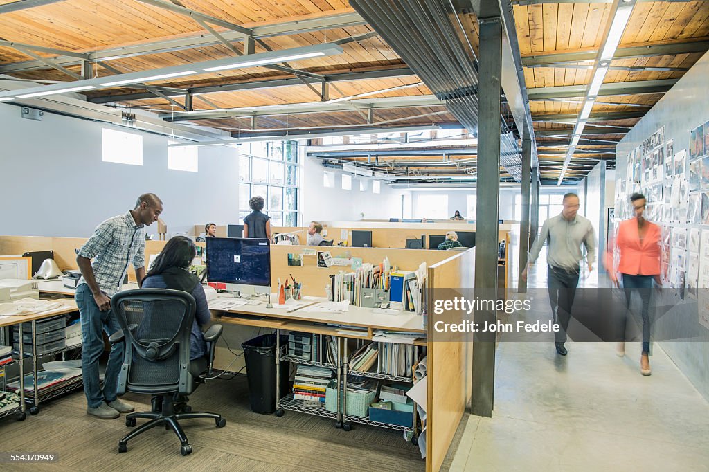 Blurred view of business people walking in office