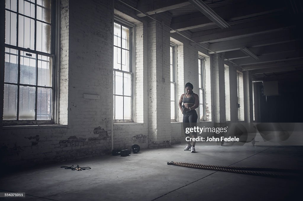 Black woman standing in dark gym