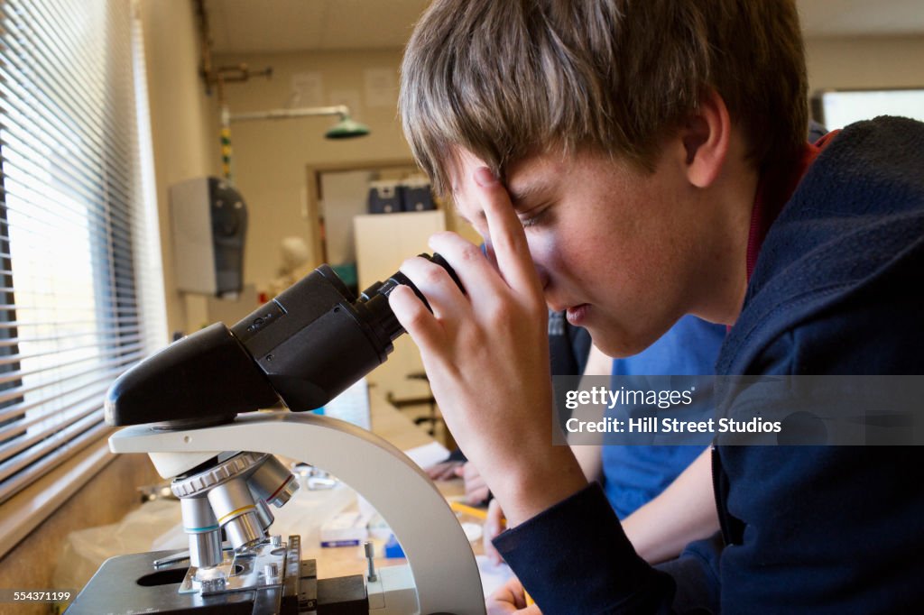 Student using microscope in science class