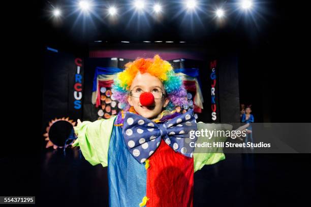 close up of boy wearing clown costume on stage - zirkus kinder stock-fotos und bilder