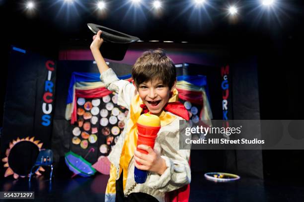 close up of boy wearing ringmaster costume on stage - zirkus kinder stock-fotos und bilder