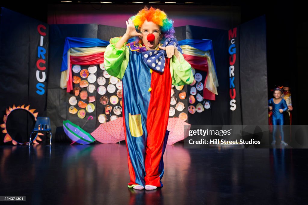 Boy wearing clown costume on stage