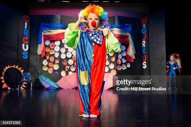 boy wearing clown costume on stage - stage seven stock pictures, royalty-free photos & images
