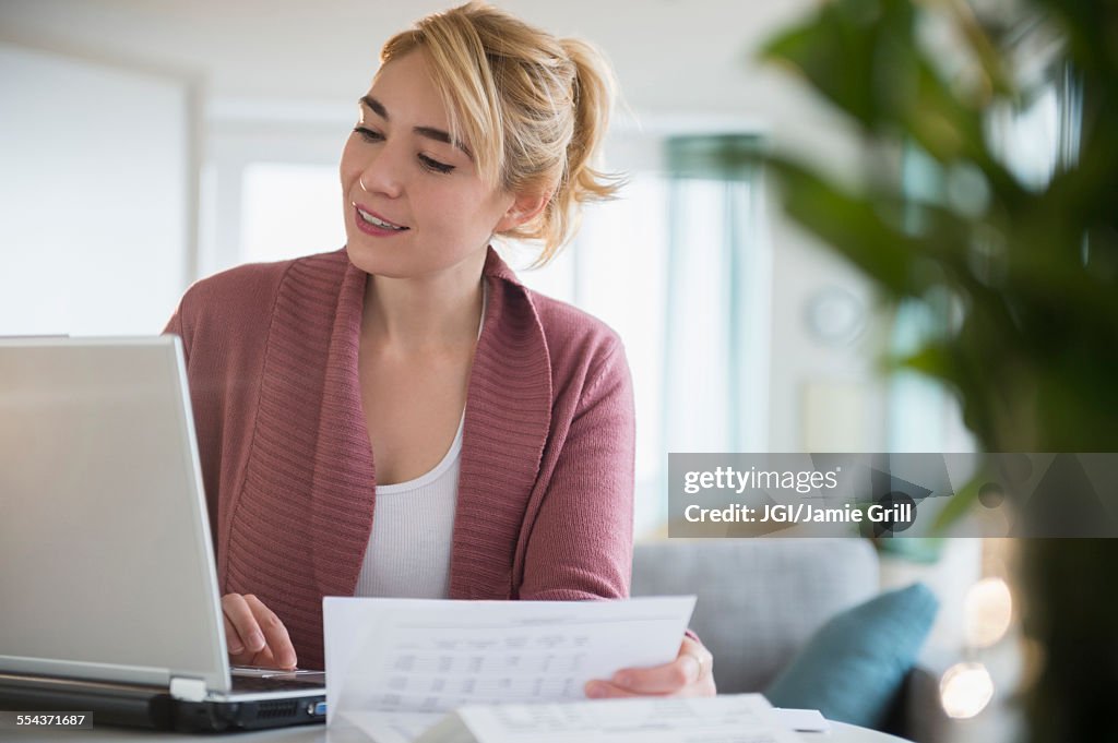 Caucasian woman paying bills online