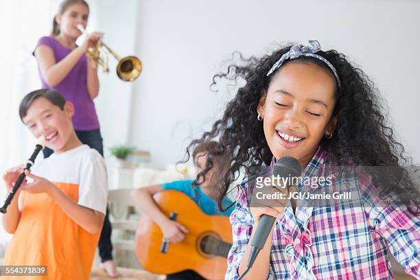 happy children singing and playing music - children holding musical instruments stock pictures, royalty-free photos & images