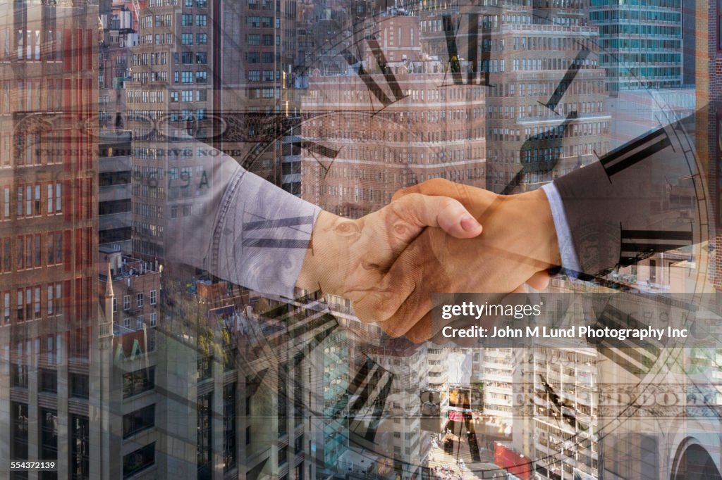 Business people shaking hands over clock and cityscape