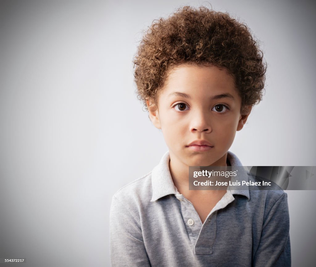Serious Mixed Race Boy With Curly Hair High-Res Stock Photo - Getty Images