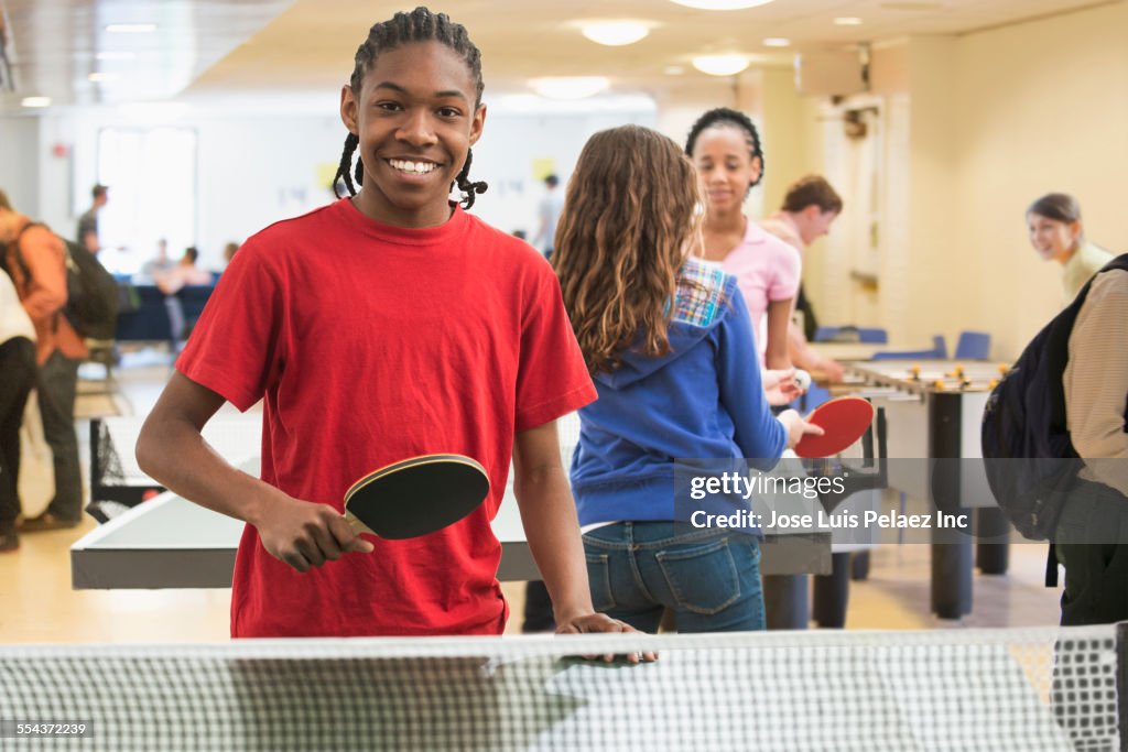 Boy playing table tennis in community center