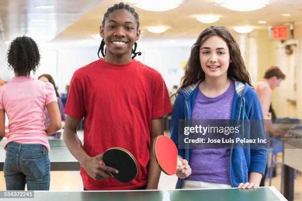 children playing table tennis in community center - mixed doubles stockfoto's en -beelden